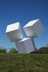 Impossibly balanced, these three white cubes form one monolithic outdoor structure.