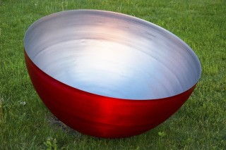 Traditional Tibetan singing bowls inspired this stainless steel bowl, powder coated silver on the inside and cherry red outside.