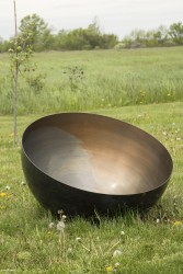 This bronze bowl is patinated brown on the exterior, is based on Tibetan singing bowls.