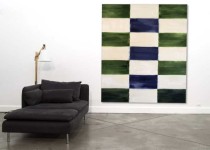 Two columns of horizontal rectangles in alternating colours of forest green and warm white frame a third, central column of warm white and s… Image 5