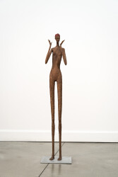 A tall slender figure stands and gestures expressively.