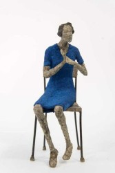 A female figure with bobbed hair in a short royal blue dress sits on a chair, arms gesturing, and head tilted as if in conversation.
