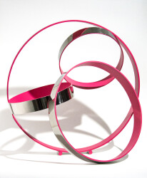 Hot pink pops from the interior of four intersecting polished stainless-steel rings in this contemporary tabletop sculpture by Quebec artist…