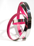 Hot pink pops from the interior of four intersecting polished stainless-steel rings in this contemporary tabletop sculpture by Quebec artist… Image 2