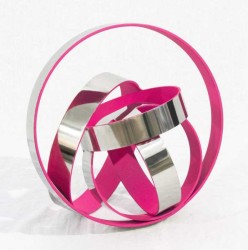 Hot pink pops from the interior of these five intersecting stainless-steel rings in this playful sculpture created by Quebec artist Phillipe…