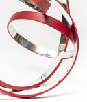 Four stainless steel rings, polished on the inside and matte red on the exterior, are curated into an elegant yet playful composition by Phi… Image 3