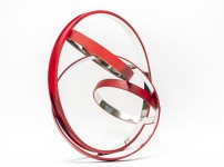 Four stainless steel rings, polished on the inside and matte red on the exterior, are curated into an elegant yet playful composition by Phi… Image 2
