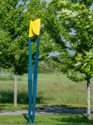 Two abstracted steel stick-like figures painted in bright primary colours intersect in this playful outdoor sculpture by R.