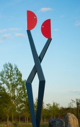 Two abstracted figures in painted steel intersect in this playful outdoor sculpture by R.