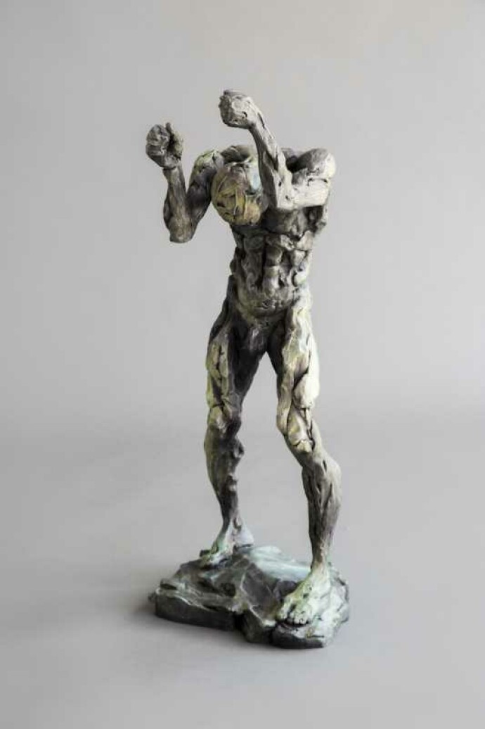 This powerful bronze sculpture of a nude male, standing, fists raised above a bowed head is by Canadian artist Richard Tosczak.