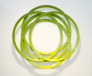 Apple green rings of flattened steel are stacked to create an elegant and playful geometric, botanical form in this wall sculpture by Canadi…