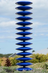 Towering steel column, painted in metallic blue.