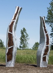 Two narrow leaf shapes rise from the ground and reach for the sky in this finely crafted aluminum sculpture by Stephane Langlois.