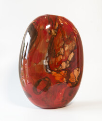 This beautiful deep red vessel in blown glass takes its organic shape and wild patterns from nature.