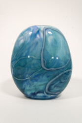 This beautiful aqua blue vessel in blown glass takes its organic shape and wild patterns from nature.
