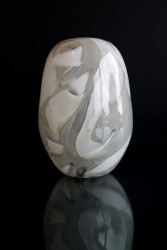 Striking gray shadows appear to float around the organic shape of this glass vessel by Susan Rankin.