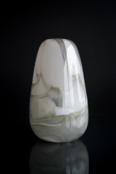 Striking gray shadows float around the organic shape of this glass vessel by Susan Rankin.