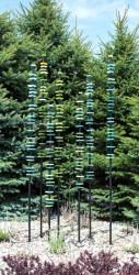 The beauty of hand-blown glass rings of blues and greens shine in the sunlight in this charming outdoor sculpture by Susan Rankin.