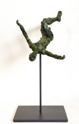 A male figure with arms outstretched twists and tumbles headfirst in this green patinated bronze sculpture.
