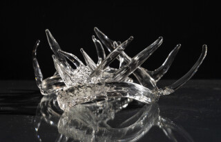 The distinctive and elegant shape of deer antlers emerges from hand-blown translucent glass to create this contemporary tabletop sculpture b…