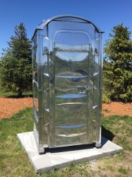 This life size replica of a Port-o-Potty, a portable toilet on wooden 2 x 4 supports in highly polished aluminum and stainless steel, explor…