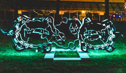 This outdoor metal sculpture of two turtles, inspired by an indigenous artist, lights up at night. Image 7