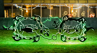This outdoor metal sculpture of two turtles, inspired by an indigenous artist, lights up at night.