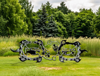 This outdoor metal sculpture of two turtles, inspired by an indigenous artist, lights up at night. Image 2