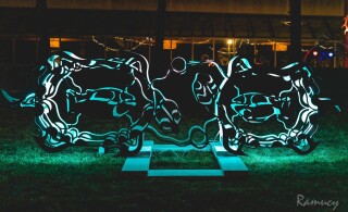 This outdoor metal sculpture of two turtles, inspired by an indigenous artist, lights up at night.