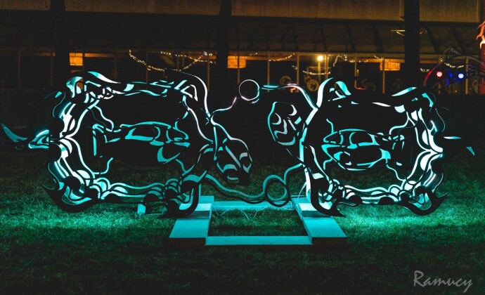 This outdoor metal sculpture of two turtles, inspired by an indigenous artist, lights up at night.