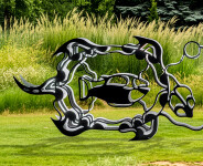 This outdoor metal sculpture of two turtles, inspired by an indigenous artist, lights up at night. Image 4