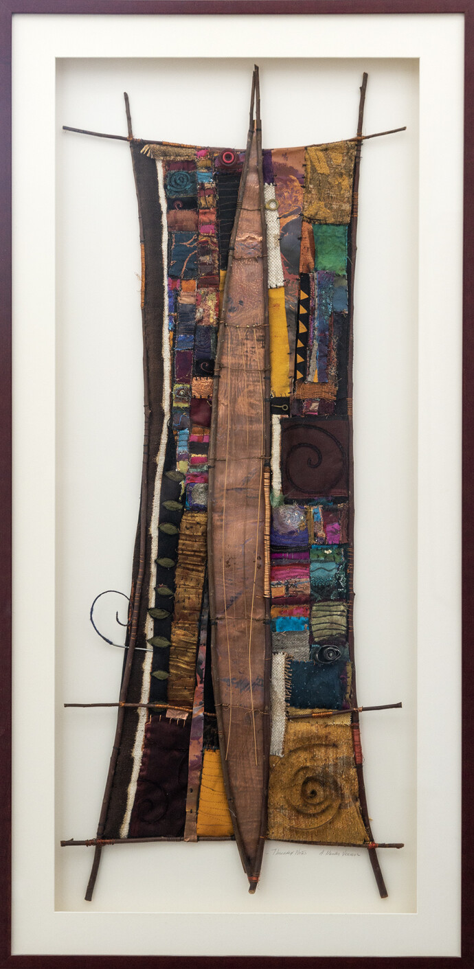 This mixed media contemporary assemblage resembles a vessel and is designed to be hung on a wall.