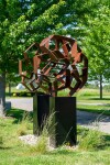 This monumental metal outdoor sculpture is rendered in a contemporary geometric form. Image 3