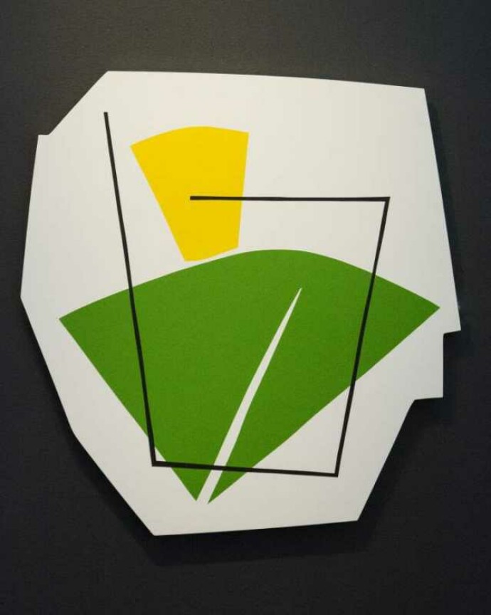 On a shaped white panel, Aron Hill plays with geometric form and bright colours—a lime green fan shape, a lemon-yellow gum drop shape, groun…