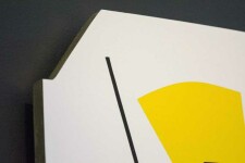 On a shaped white panel, Aron Hill plays with geometric form and bright colours—a lime green fan shape, a lemon-yellow gum drop shape, groun… Image 4