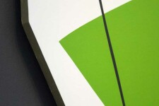 On a shaped white panel, Aron Hill plays with geometric form and bright colours—a lime green fan shape, a lemon-yellow gum drop shape, groun… Image 3