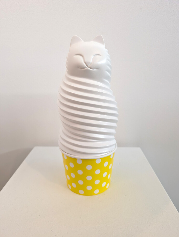 This pop art table top sculpture is a playful colorful figure of a cat.