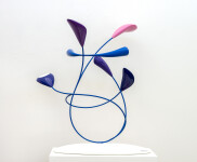 This abstract pop art table top wooden sculpture depicts flowers. Image 2