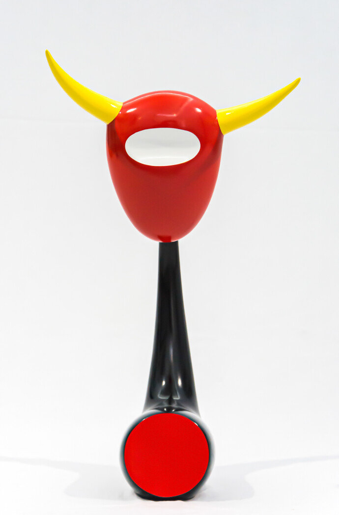 The distinctive shape of a bull’s head attached to a horn-like stand pops in glossy bright colours of red, yellow and black in this whimsica…