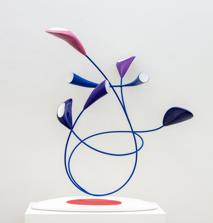 This abstract pop art table top wooden sculpture depicts flowers.