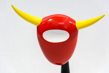 The distinctive shape of a bull’s head attached to a horn-like stand pops in glossy bright colours of red, yellow and black in this whimsica… Image 4