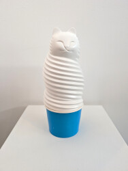 This pop art tabletop sculpture is a playful colorful figure of a cat.