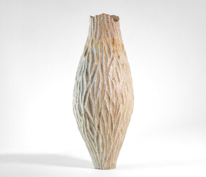 This unique tall ceramic vessel is handmade.