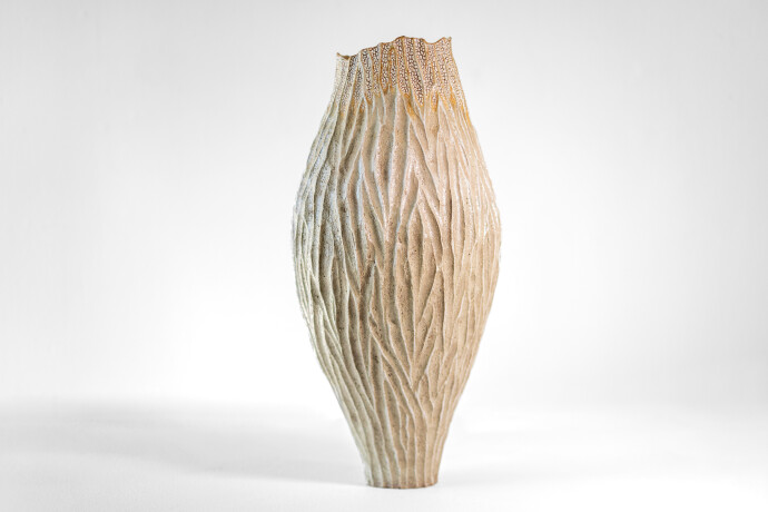 This unique tall ceramic vessel is handmade.