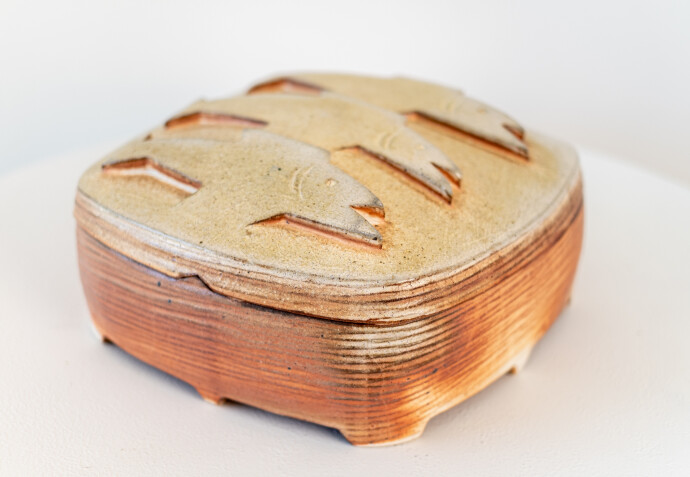 This contemporary ceramic box by Bruce Cochrane has a fish design on its lid.