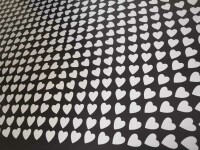 Small silver hearts in a precise geometric design on a black ground create an optical pattern of concentric squares. Image 2