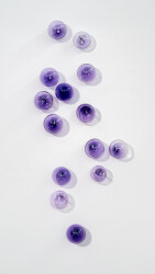 This contemporary, purple-colored, glass wall sculpture was created by Cheryl Wilson Smith.