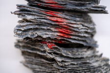 This contemporary glass wall sculpture resembles rock. Image 7