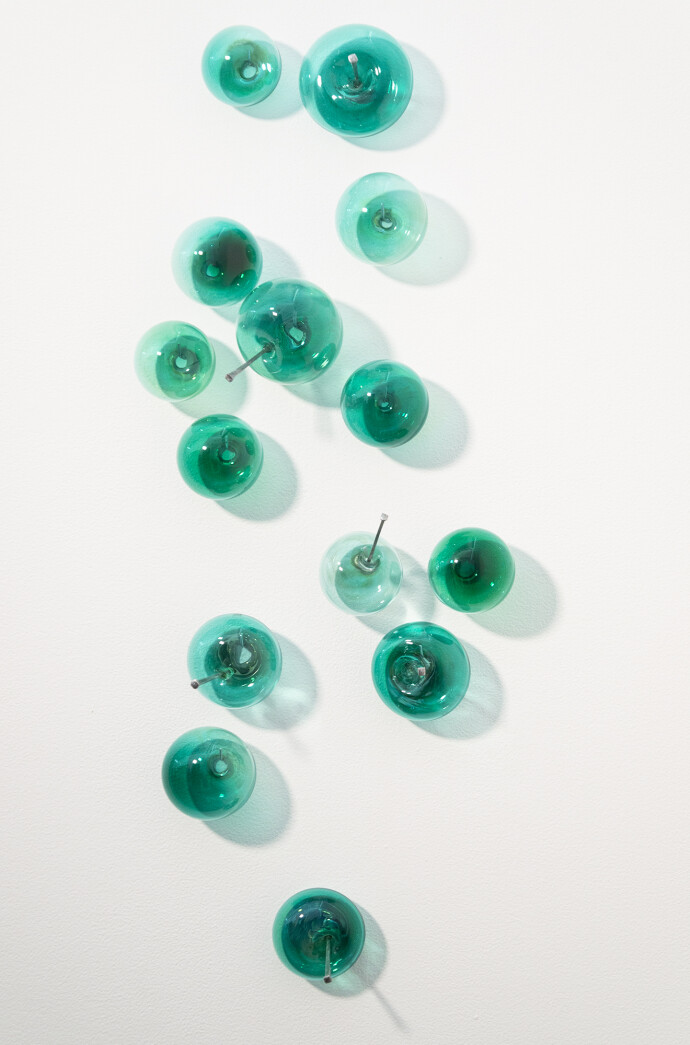 This contemporary wall sculpture features turquoise coloured glass bubbles.