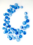 This contemporary glass wall sculpture features cerulean colored bubbles. Image 3